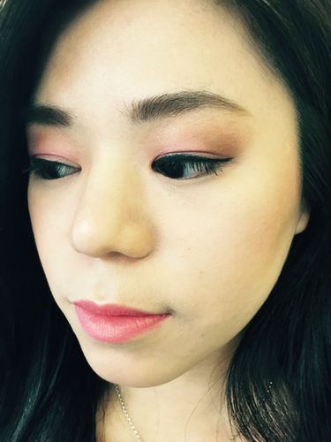 A happy client with pink eye shadow and subtle pink lips