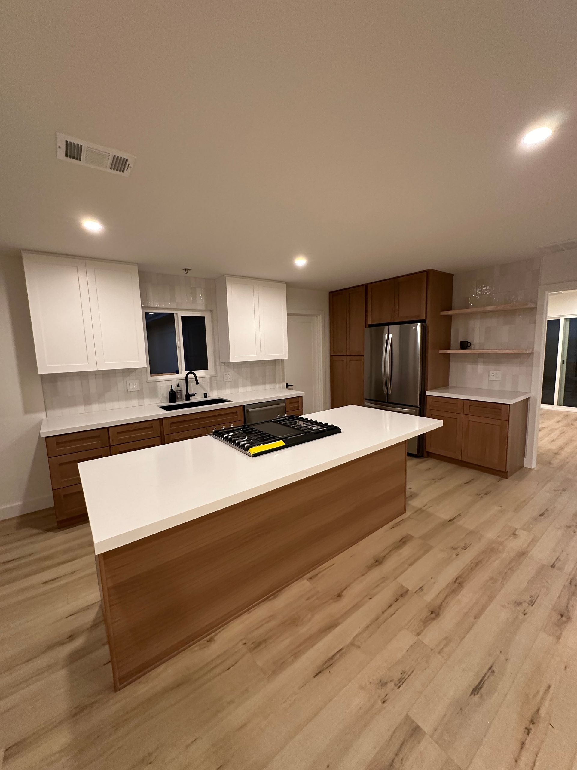 A kitchen with a large island in the middle of the room.