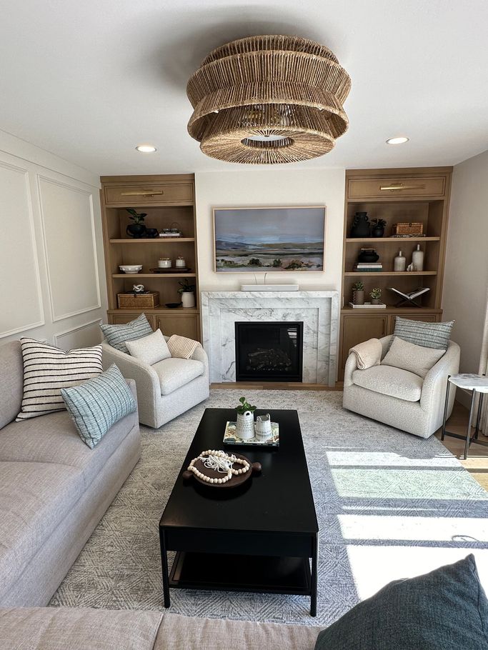 A living room filled with furniture and a fireplace.