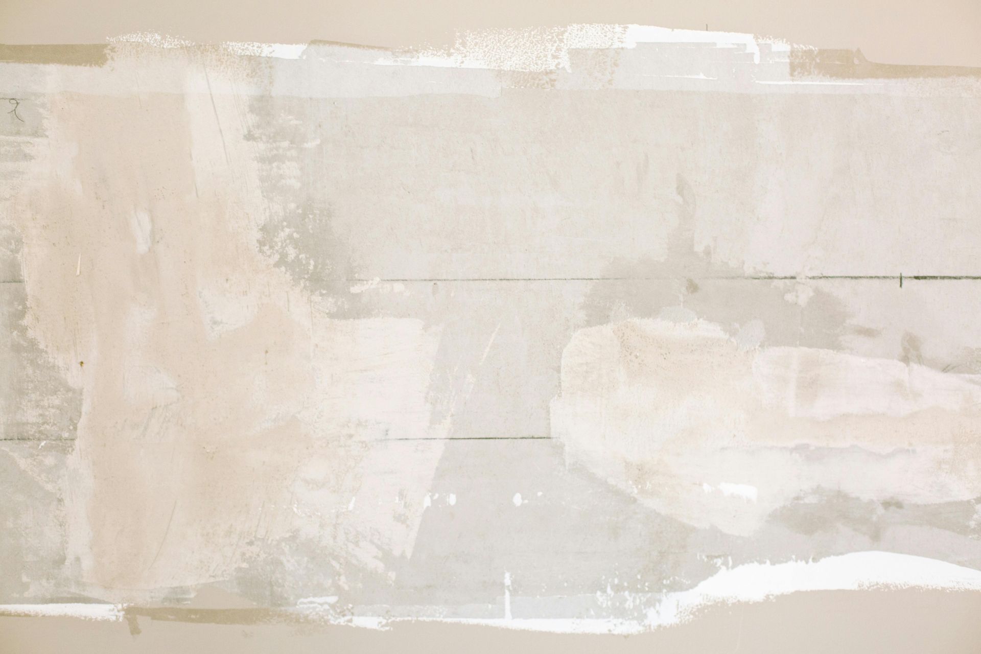 A close up of a piece of white paint on a wall.