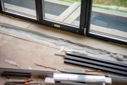 A sliding glass door is being installed in a house.