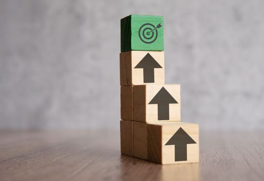 Business growth strategy illustration with rising blocks and target