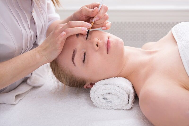 A Woman is Getting her Eyebrows done at a Beauty Salon — Bernadette's Beauty Care in Sarina, QLD