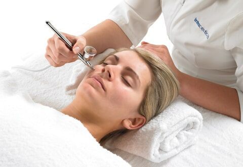 A Woman is Getting a Facial Treatment at a Spa — Bernadette's Beauty Care in Sarina, QLD