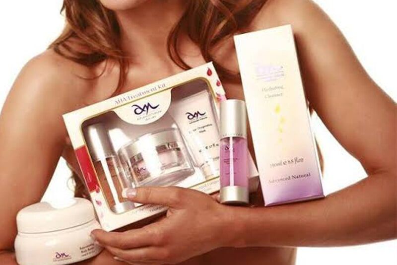 A Woman is Holding a box of dm Cosmetics — Bernadette's Beauty Care in Sarina, QLD