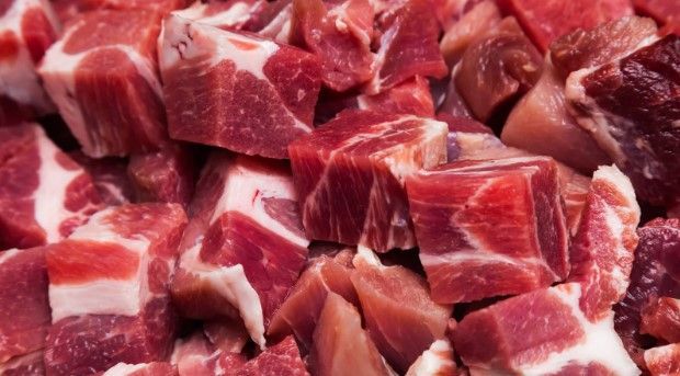 A pile of chopped meat is sitting on a table.