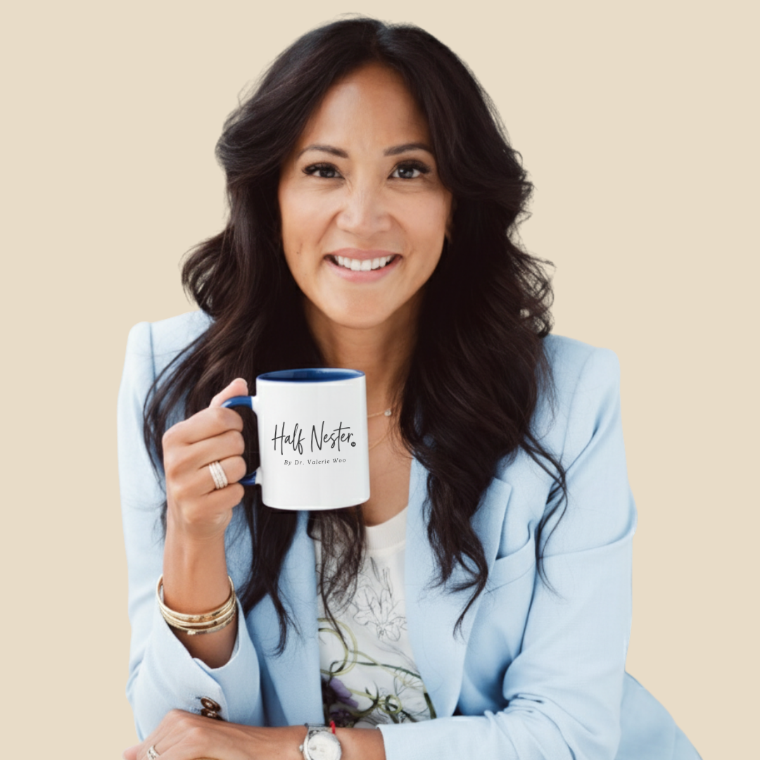 Woman in light blue blazer holds a mug that says 
