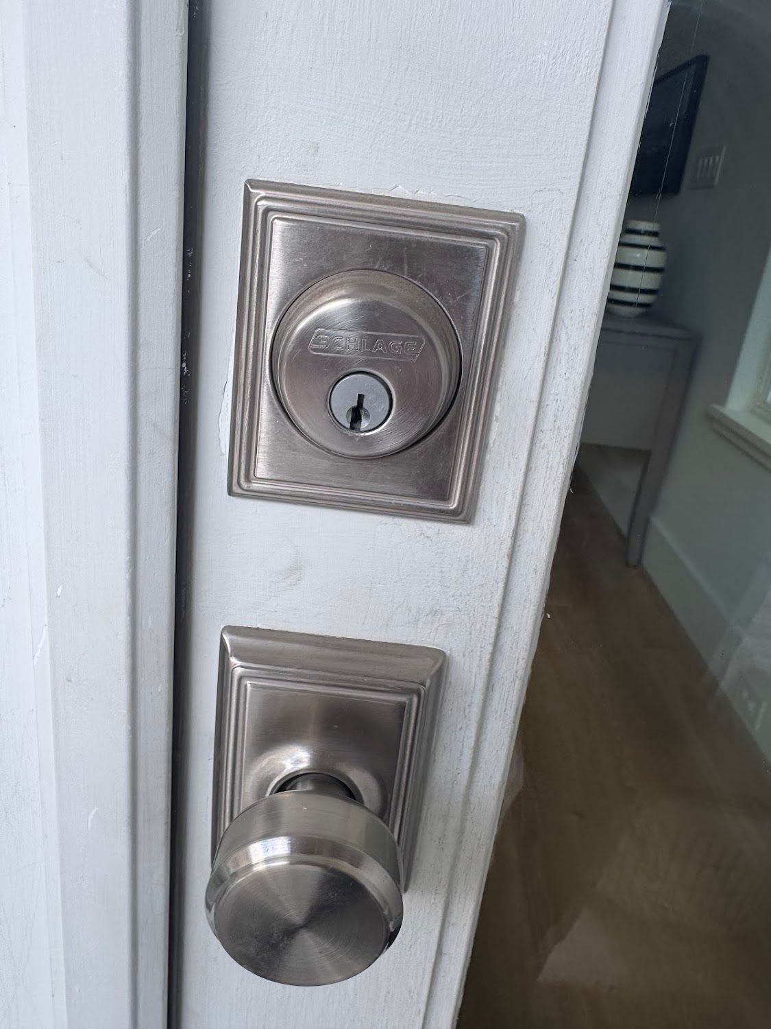 Door with a deadbolt lock and doorknob in brushed nickel finish.