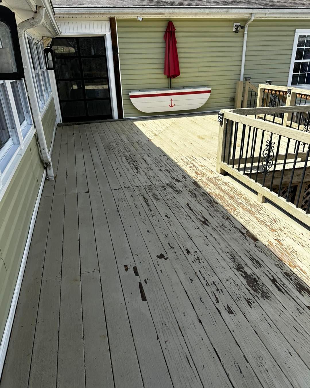 A wooden deck with a boat and umbrella on it.