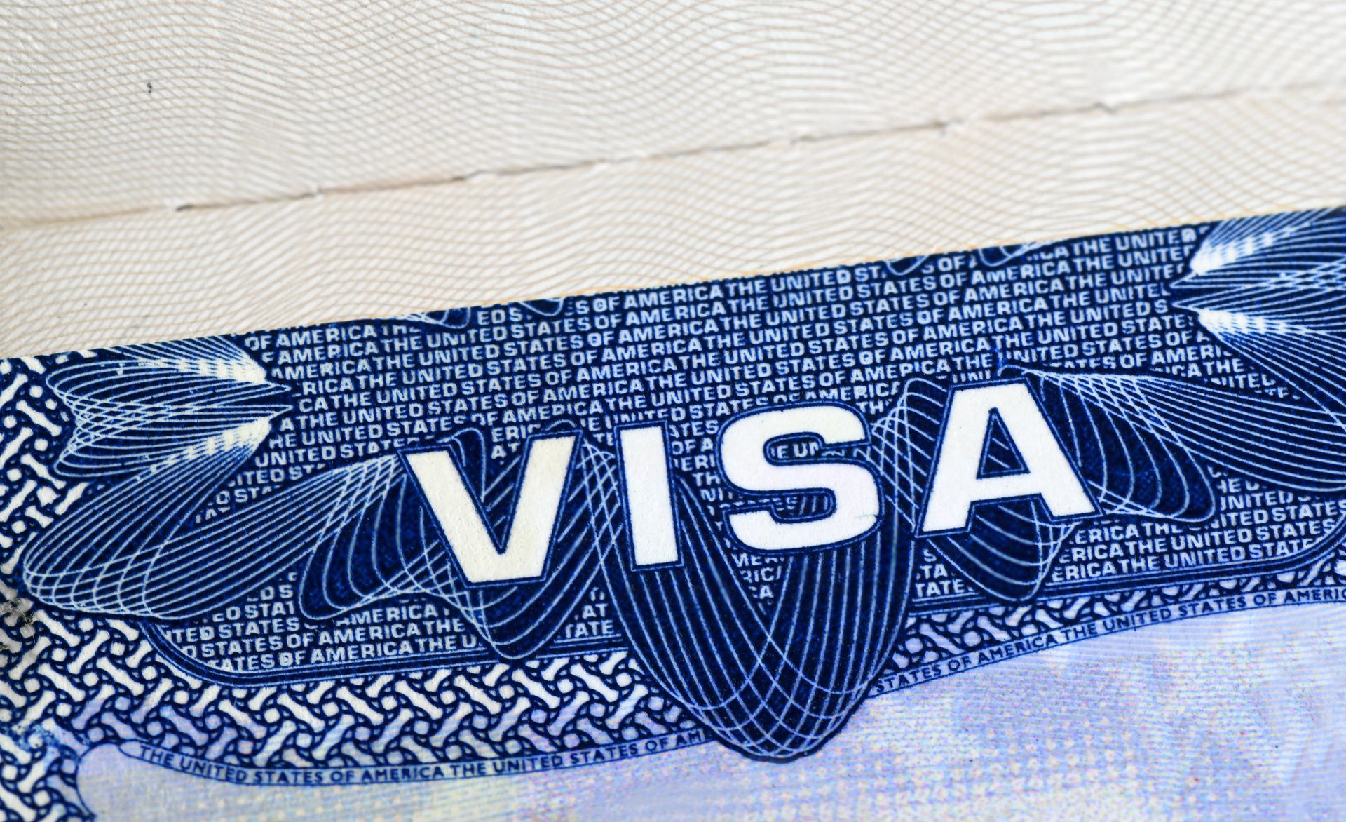 A close up of a visa on a white surface