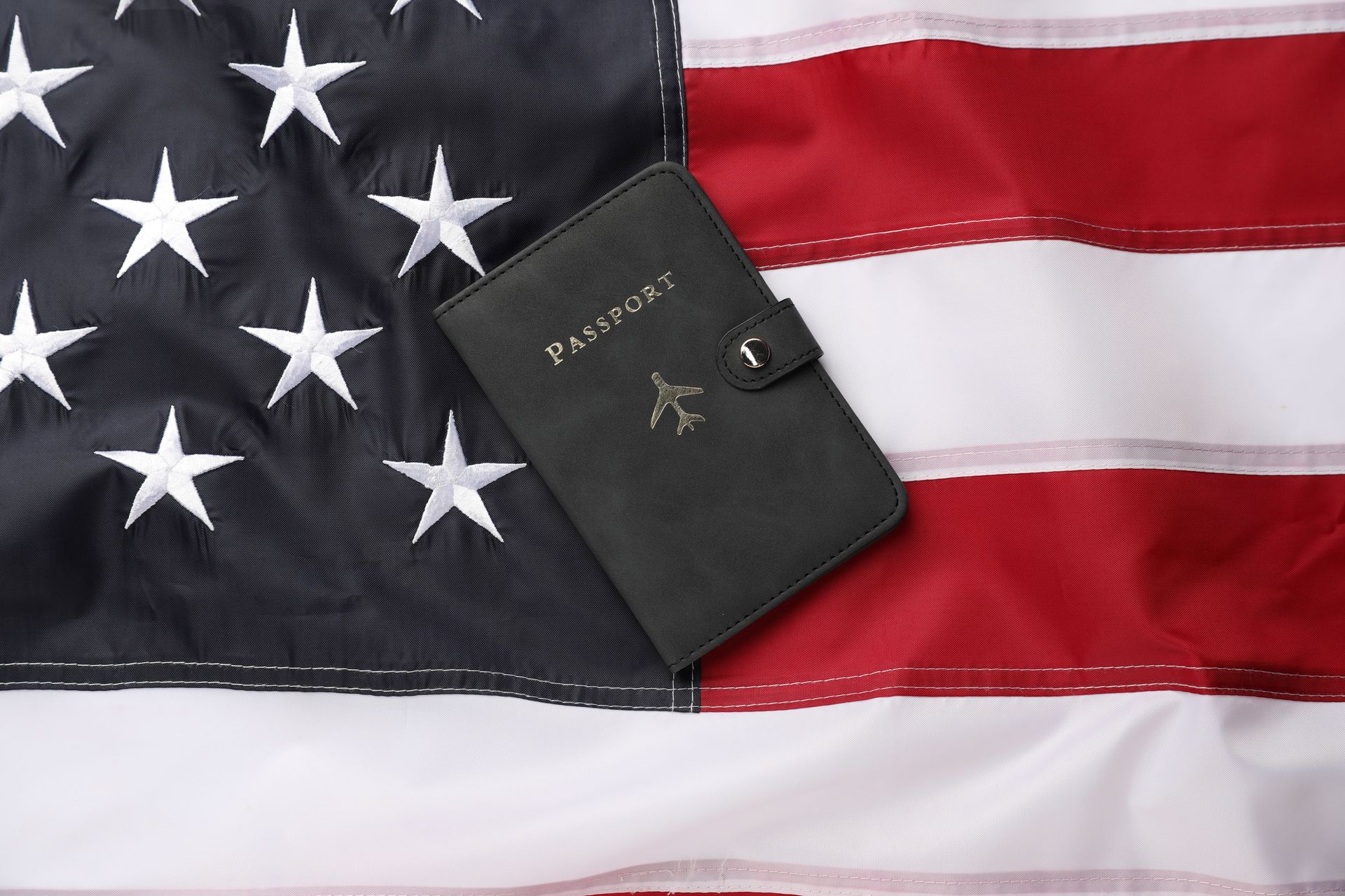 Black passport on American flag.