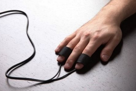 Man's finger connected with polygraph test wire