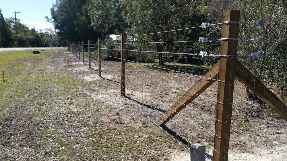Wooden Fence With Wire Strands in a Rural Setting — Sweet's Rural Fencing & Machinery in Lake Macdonald, QLD