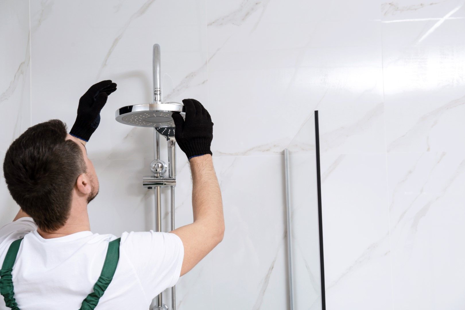 An image of a person working on Bathroom Tub and Shower Remodeling Services in Airdrie, AB