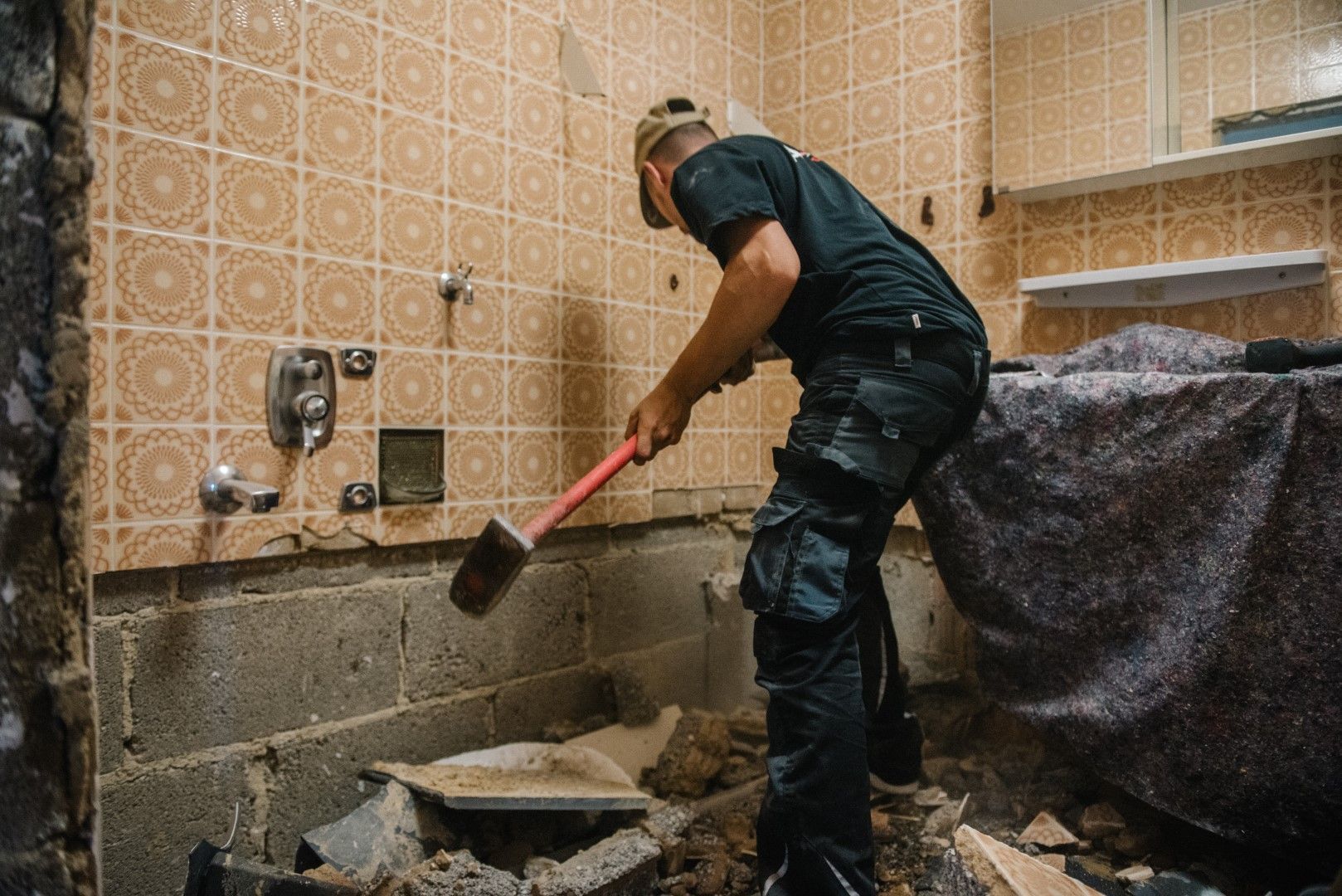 An image of a person working on Bathroom Tile Remodeling Services in Airdrie, AB