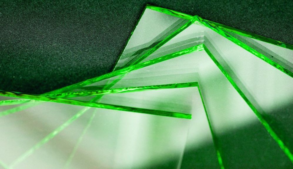 A Close Up Of A Piece Of Green Glass On A Table — Townsville Stained Glass In Mackay, QLD