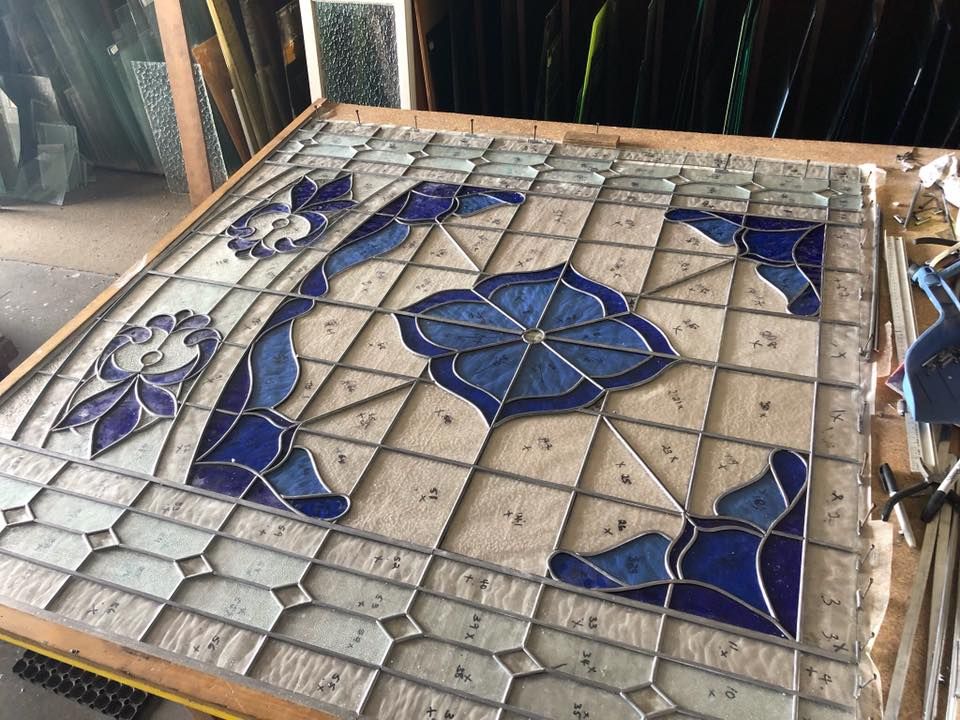 A Stained Glass Window With A Blue Flower On It — Townsville Stained Glass In Townsville, QLD