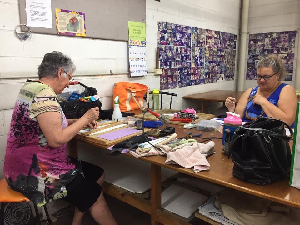 Two Women Are Sitting At A Table Making Crafts — Townsville Stained Glass In Townsville, QLD 