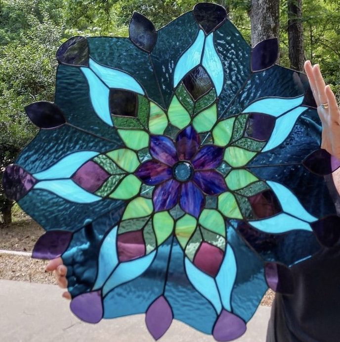 A Person Is Holding A Stained Glass Flower In Their Hands — Townsville Stained Glass In Aitkenvale, QLD