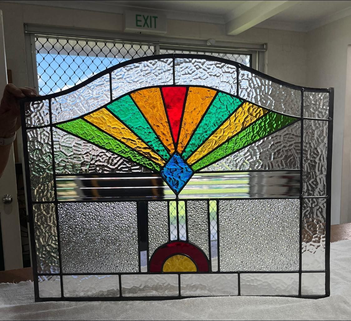 A Stained Glass Window In Front Of An Exit Sign — Townsville Stained Glass In Charters Towers, QLD