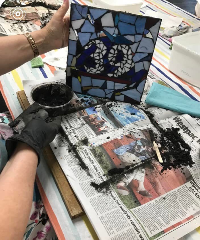 A Person Is Making A Mosaic With The Number 20 On It — Townsville Stained Glass In Charters Towers, QLD
