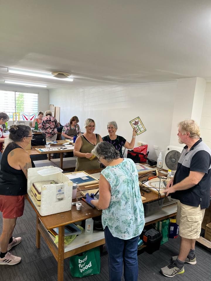 A Group Of People Are Standing Around Tables In A Room — Townsville Stained Glass In Charters Towers, QLD