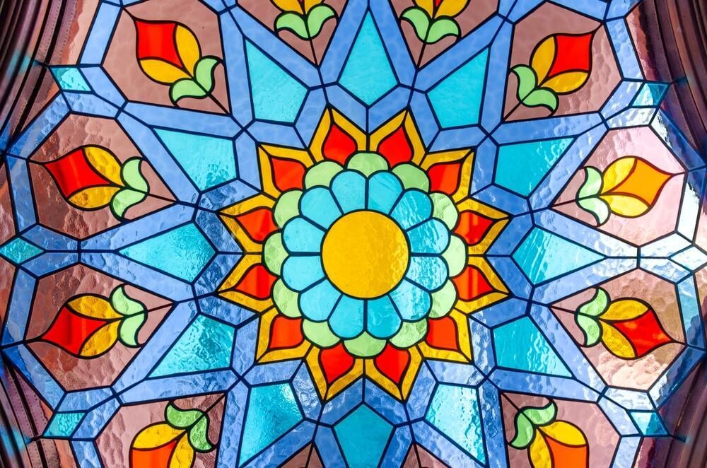 A Close Up Of A Stained Glass Window With A Blue And Brown Pattern — Townsville Stained Glass In Charters Towers, QLD