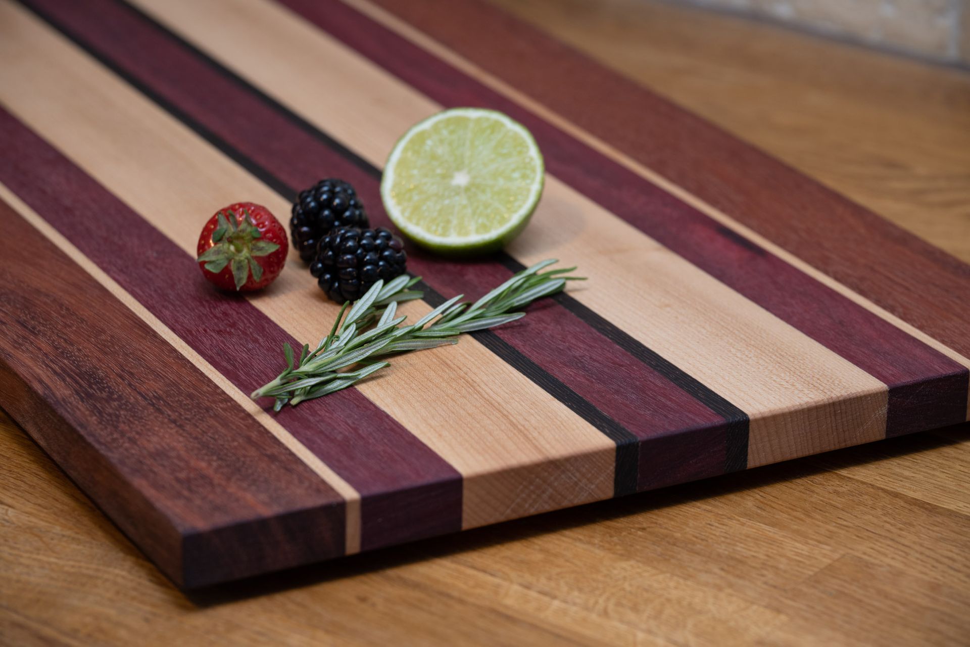 Photo of Harvey in the workshop cutting padauk strips for making chopping boards