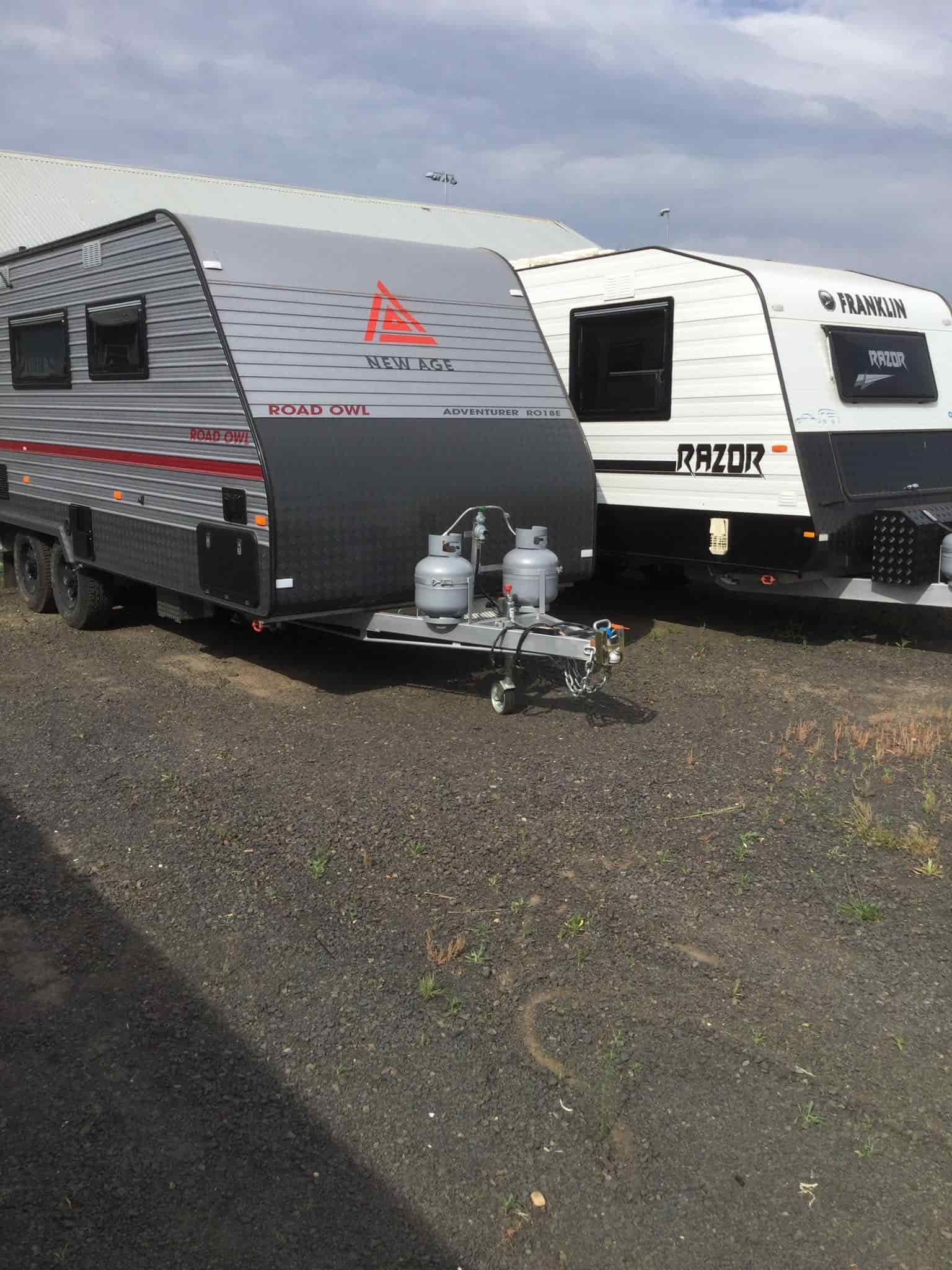 Two Caravans Are Parked Next to Each Other in a Gravel Lot — B & C Caravan Service Pty Ltd In Dubbo, NSW
