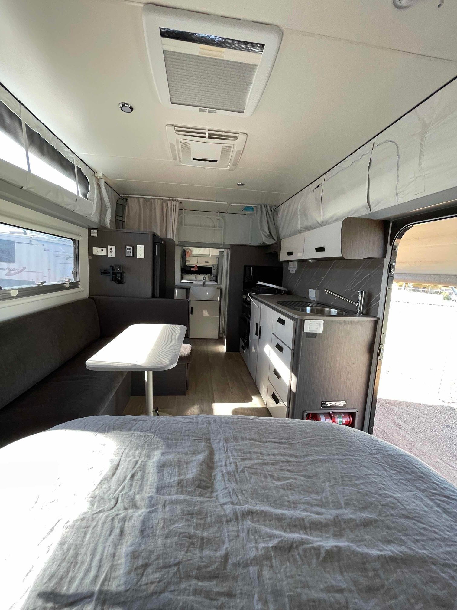 Modern RV interior showcasing a cozy living space with a bed &mdash; B & C Caravan Service Pty Ltd In Dubbo, NSW