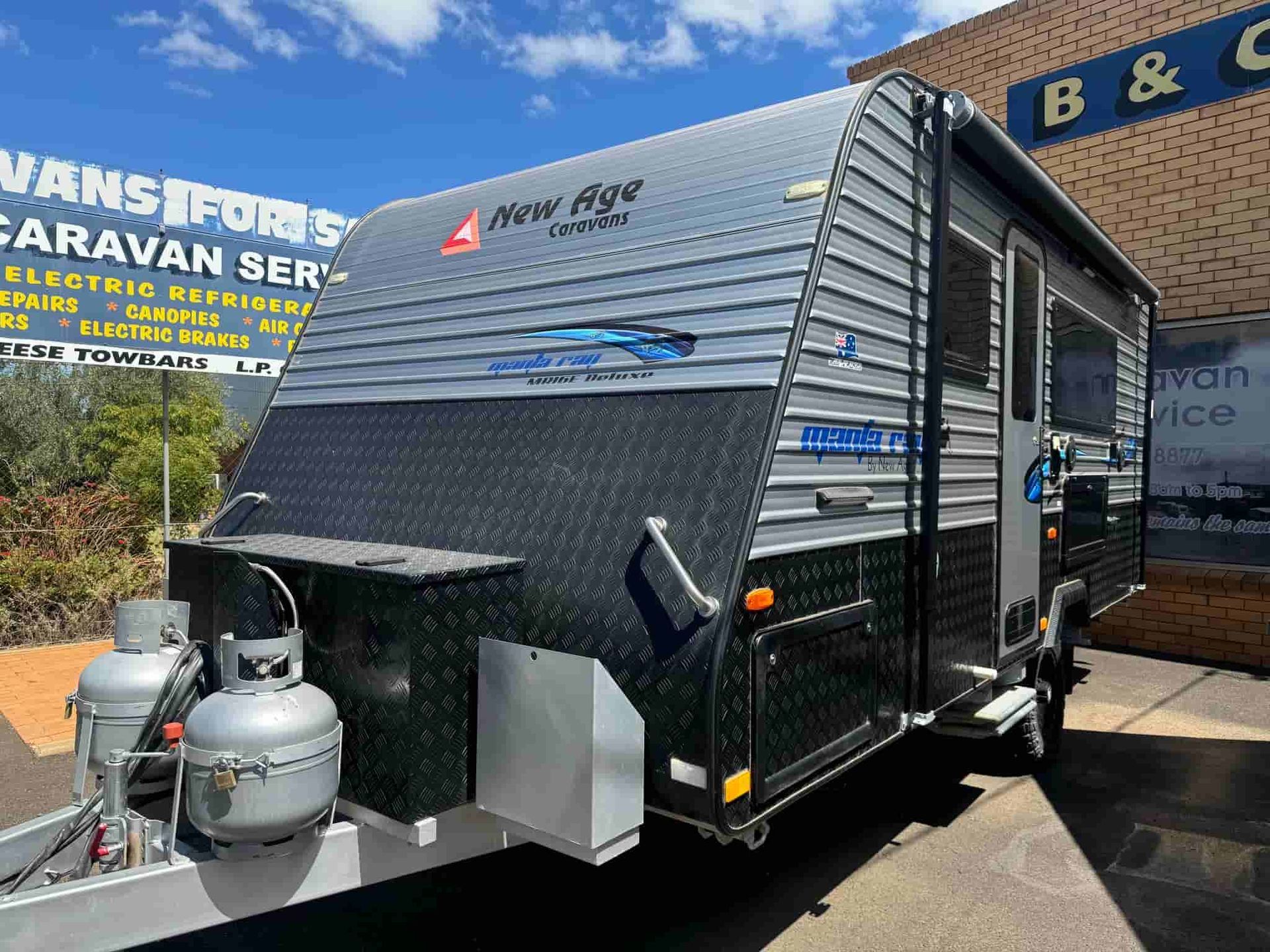 A Caravan is Parked in Front of a Building — B & C Caravan Service Pty Ltd In Dubbo, NSW