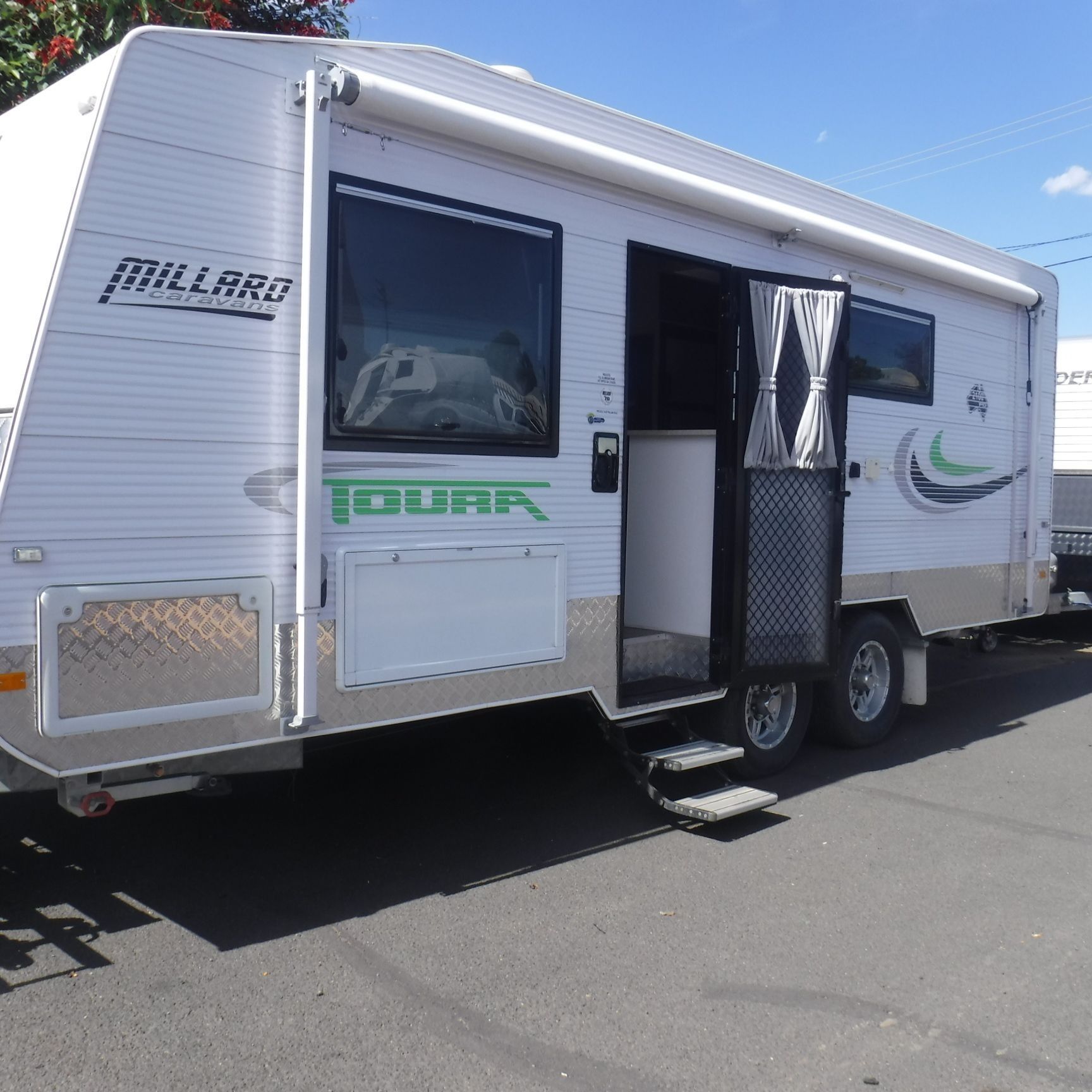 A White Rv is Parked on the Side of the Road — B & C Caravan Service Pty Ltd In Dubbo, NSW