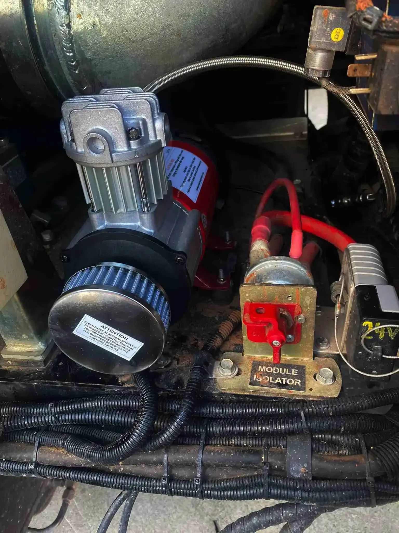 A close up of a air compressor in a car engine.