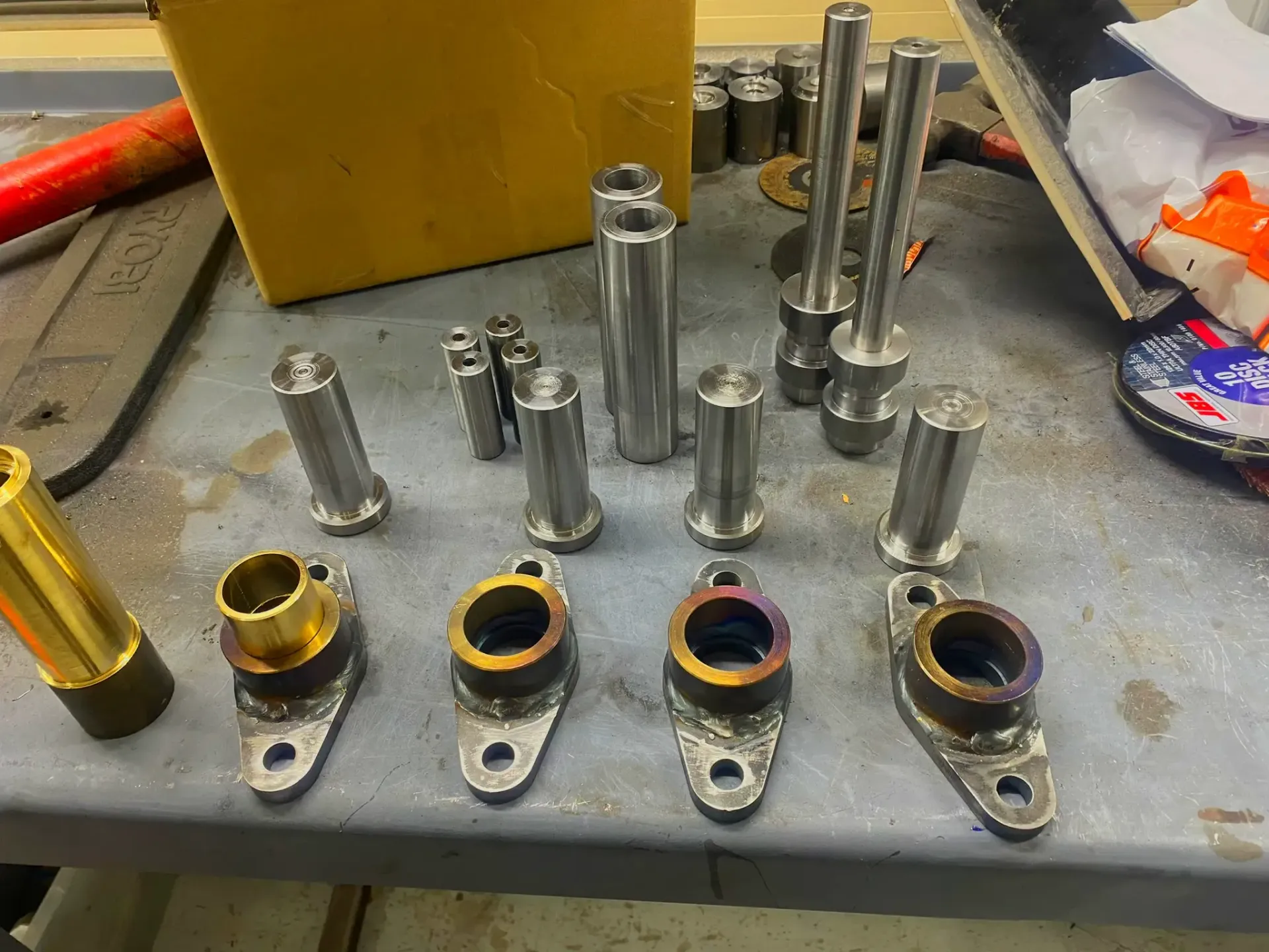 A bunch of metal parts are sitting on a table.