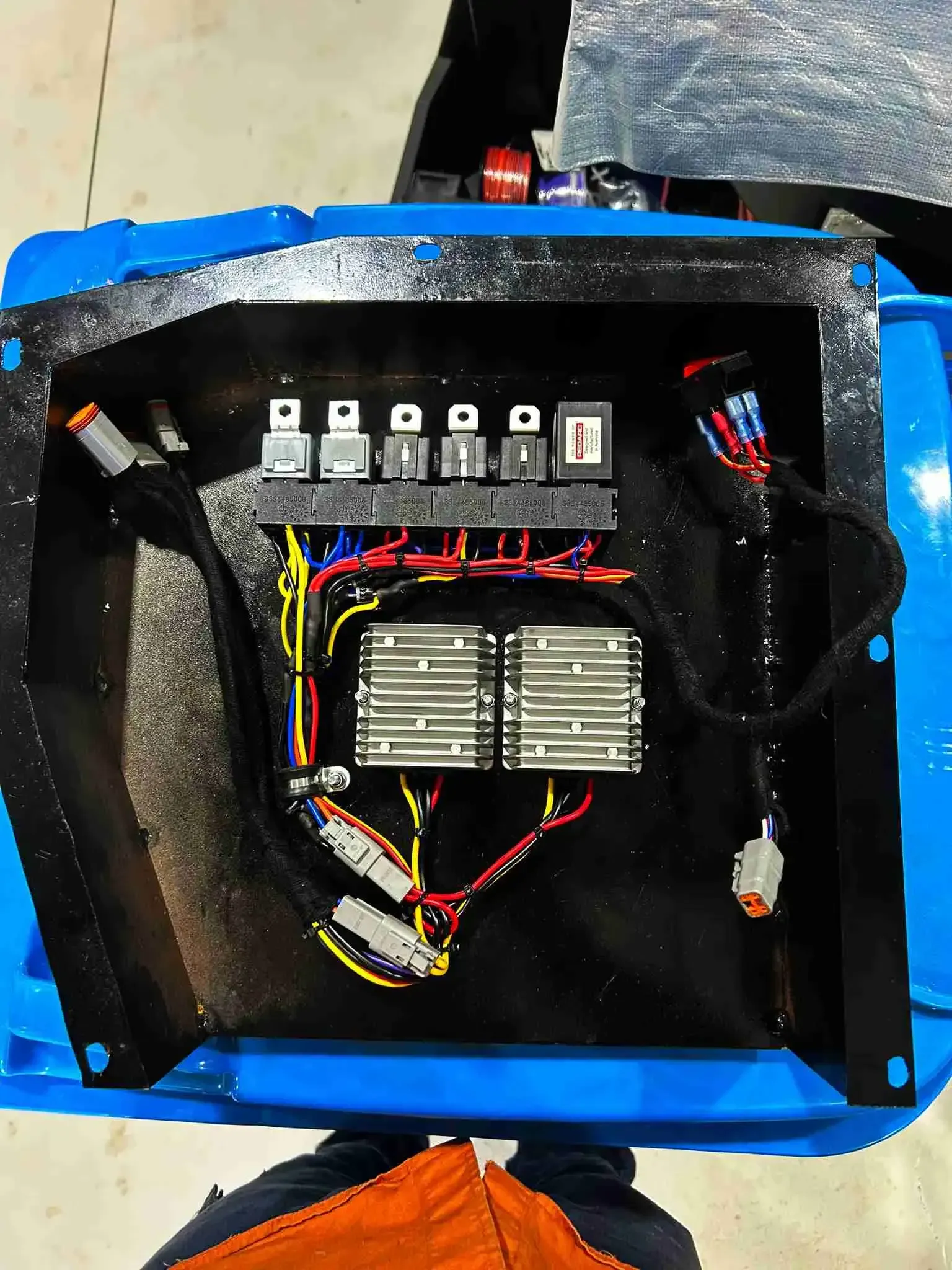 A blue box with a bunch of wires inside of it