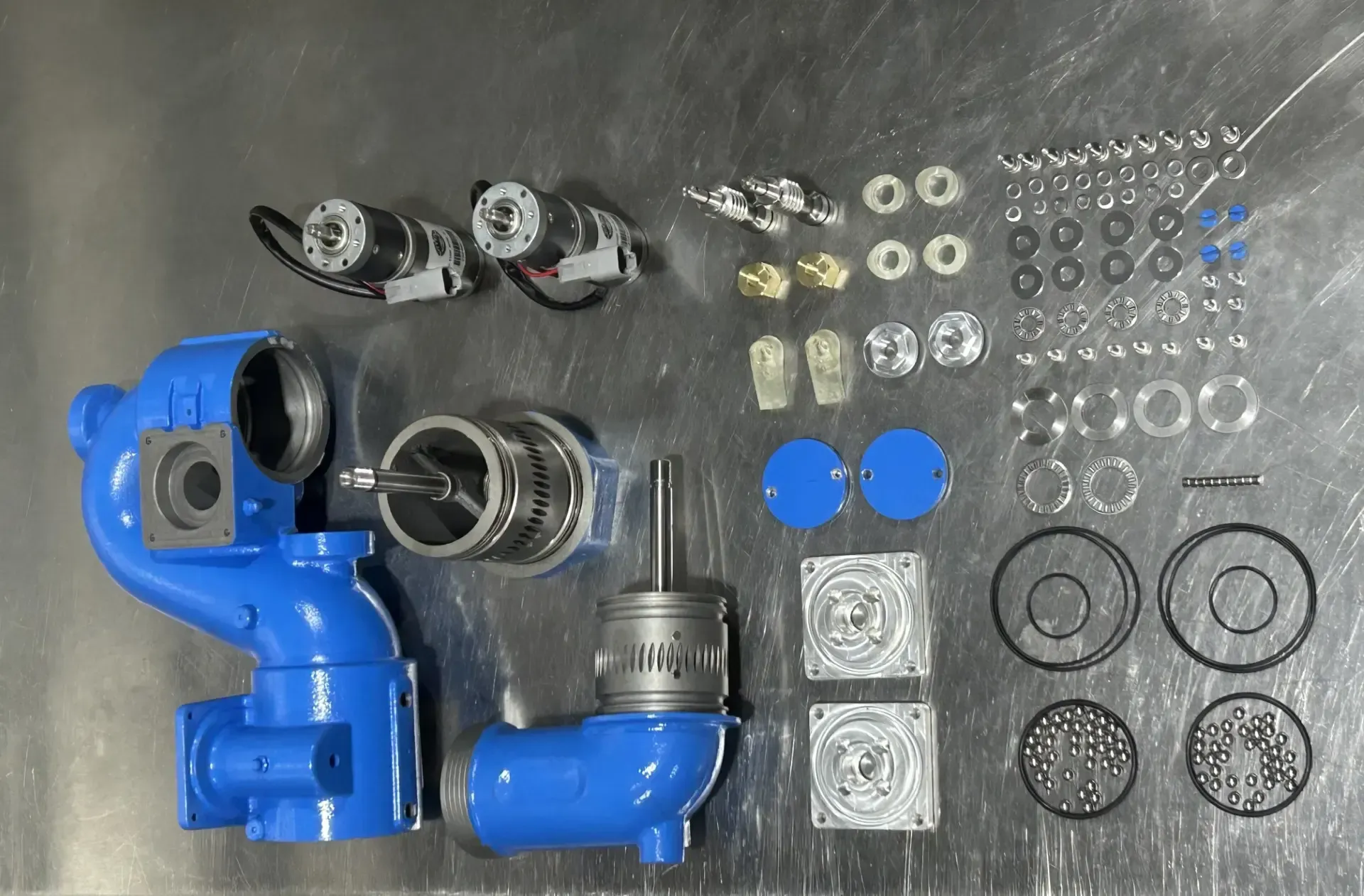 A bunch of blue pipes and parts on a table