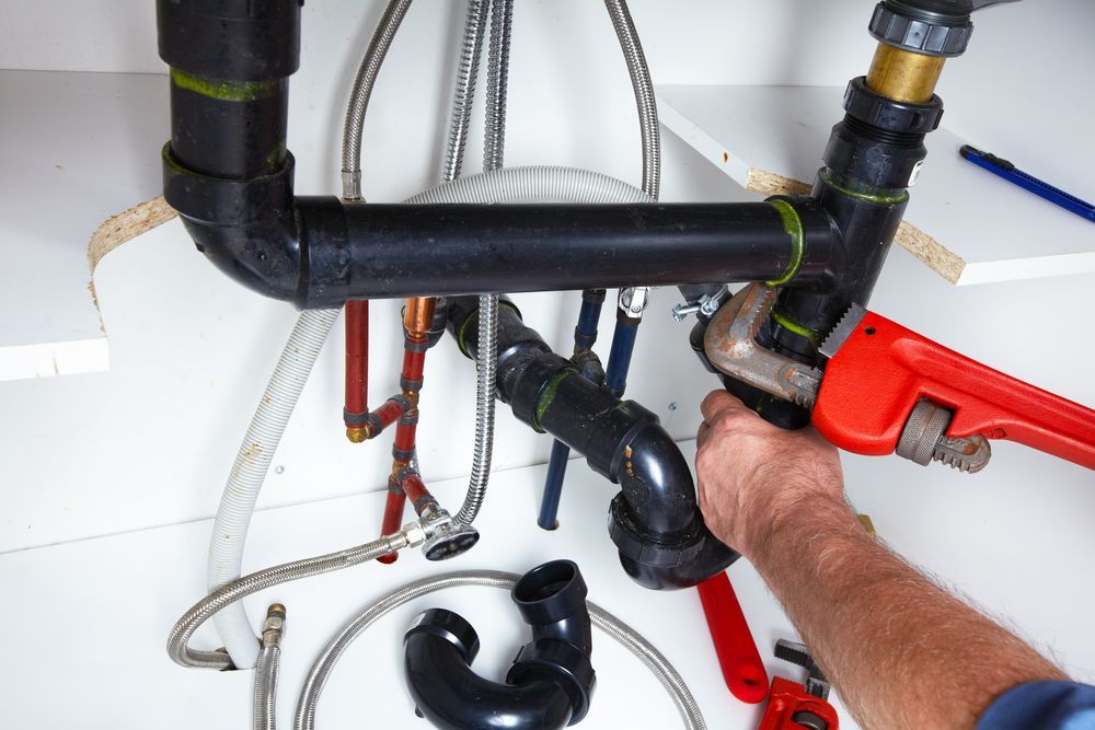 Plumber Uses a Red Pipe Wrench to Work — Southern Trade Services in Warburton, VIC