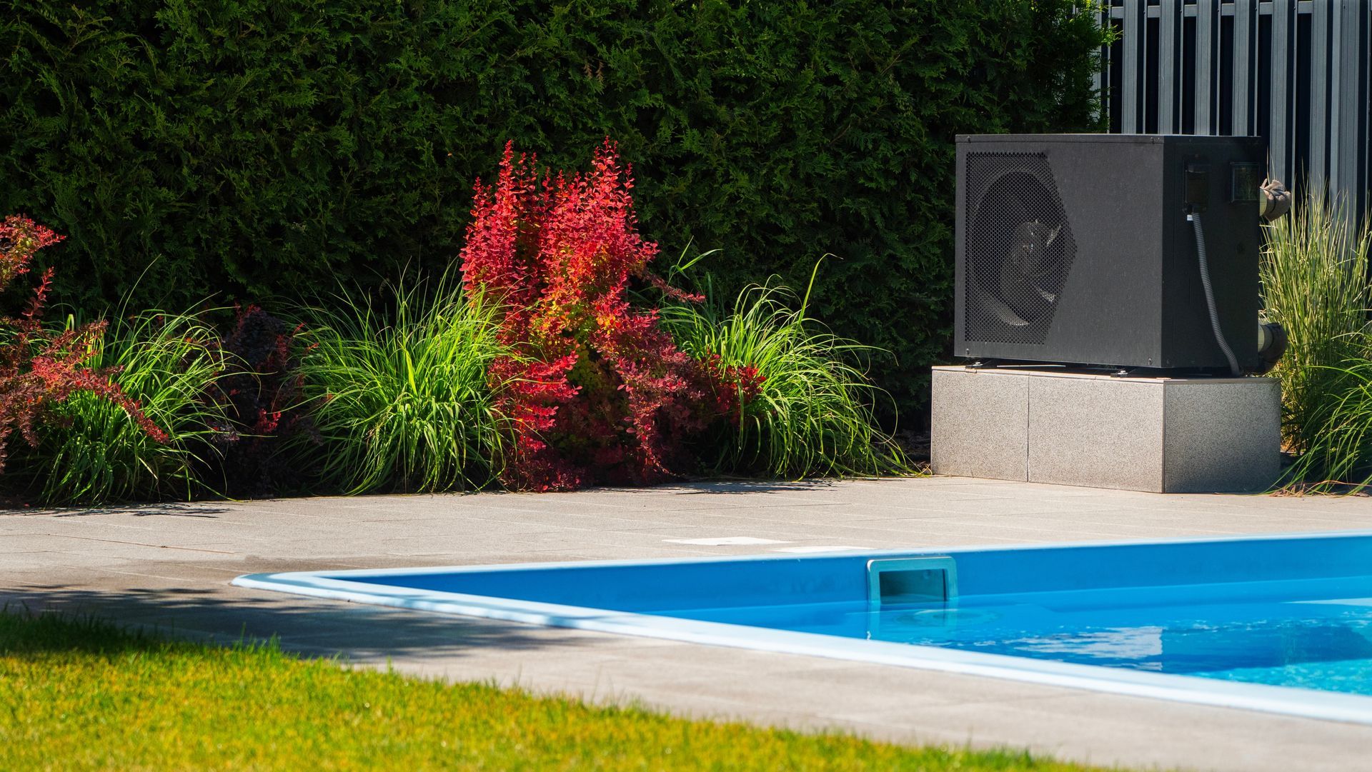 Pool Heat Pump Sits on a Concrete Block Beside a Swimming Pool — Southern Trade Services in Warburton, VIC