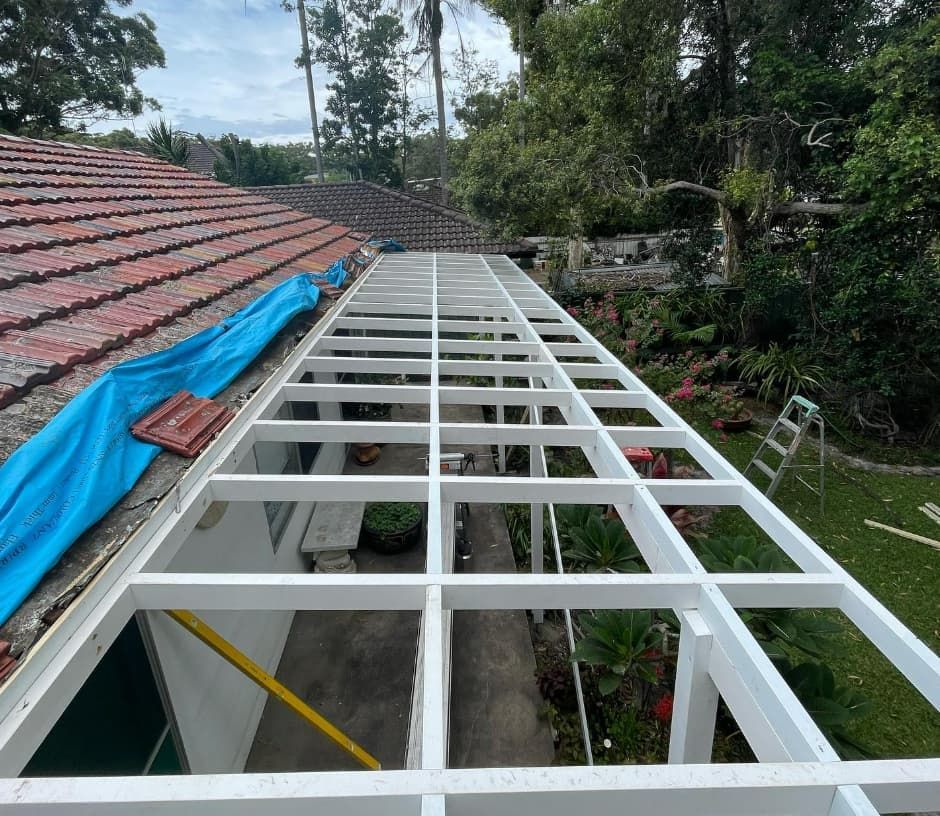 A White Pergola Is Being Built On The Roof Of A House — Penman Projects In Salamander Bay, NSW