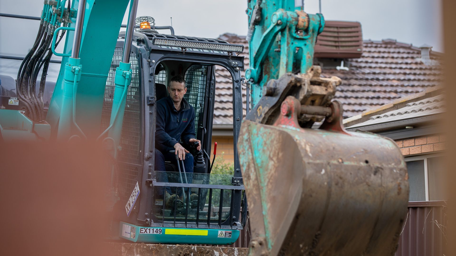 Staff in a digger for a trench — Frank Plumbing In Delacombe, VIC