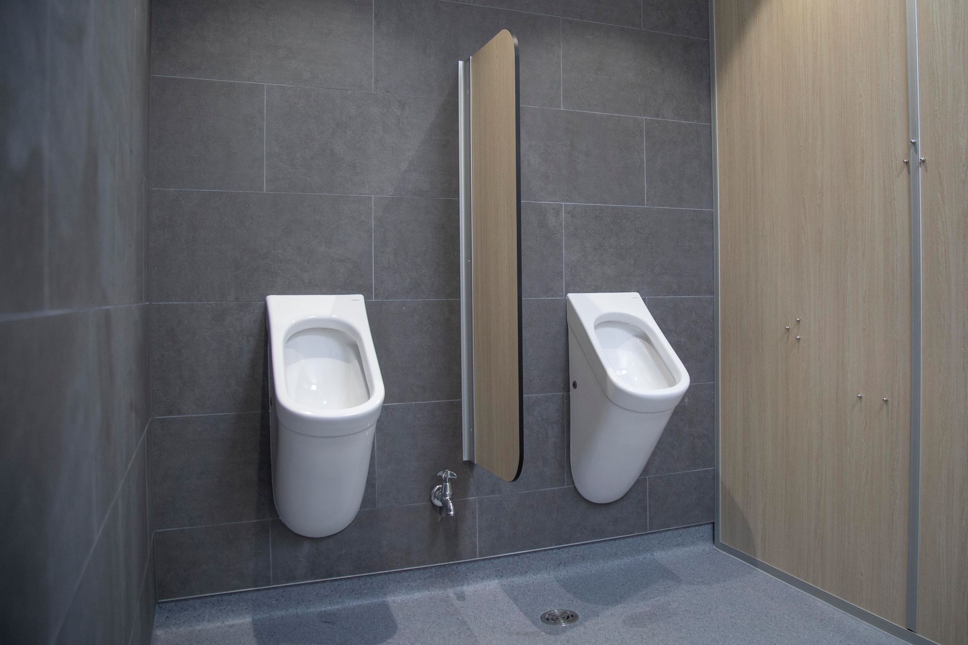 urinals in a modern public bathroom— Frank Plumbing In Delacombe, VIC