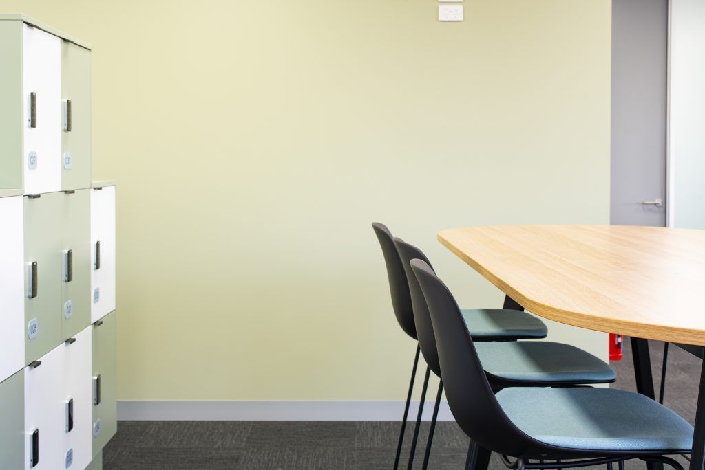 A Conference Room With A Table And Chairs And Lockers — Frank Plumbing In Delacombe, VIC