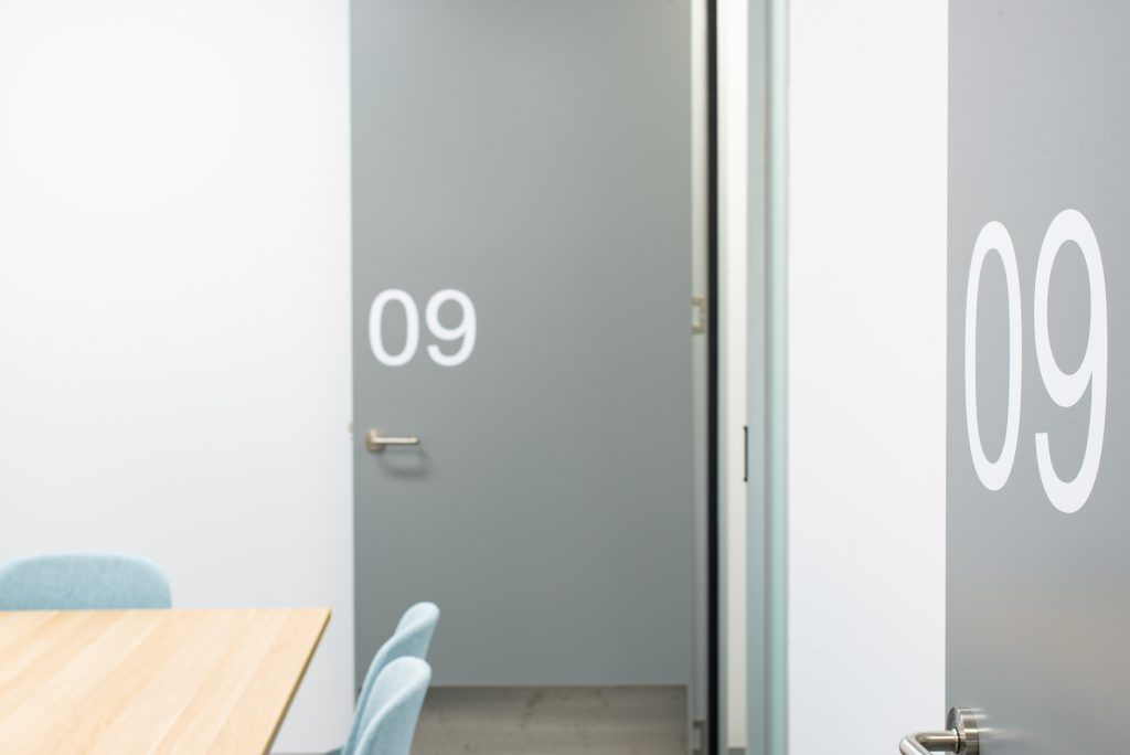 A Room With A Table And Chairs And A Door With The Number 09 On It — Frank Plumbing In Delacombe, VIC