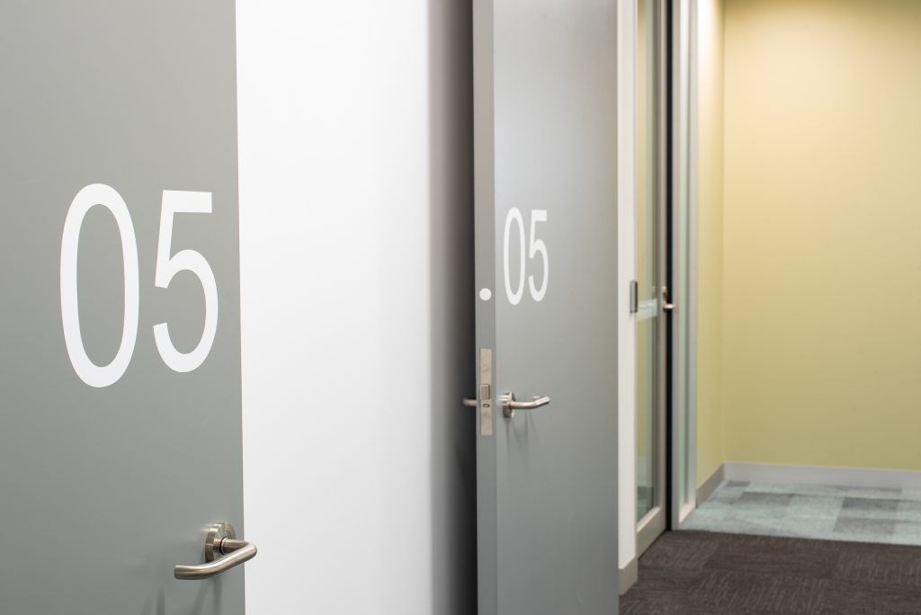 A Hallway With Two Doors With The Number 05 On Them — Frank Plumbing In Delacombe, VIC