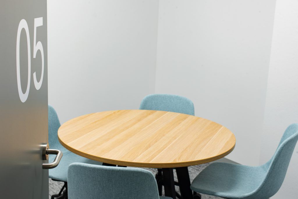 A Small Meeting Room With A Round Table And Chairs — Frank Plumbing In Delacombe, VIC