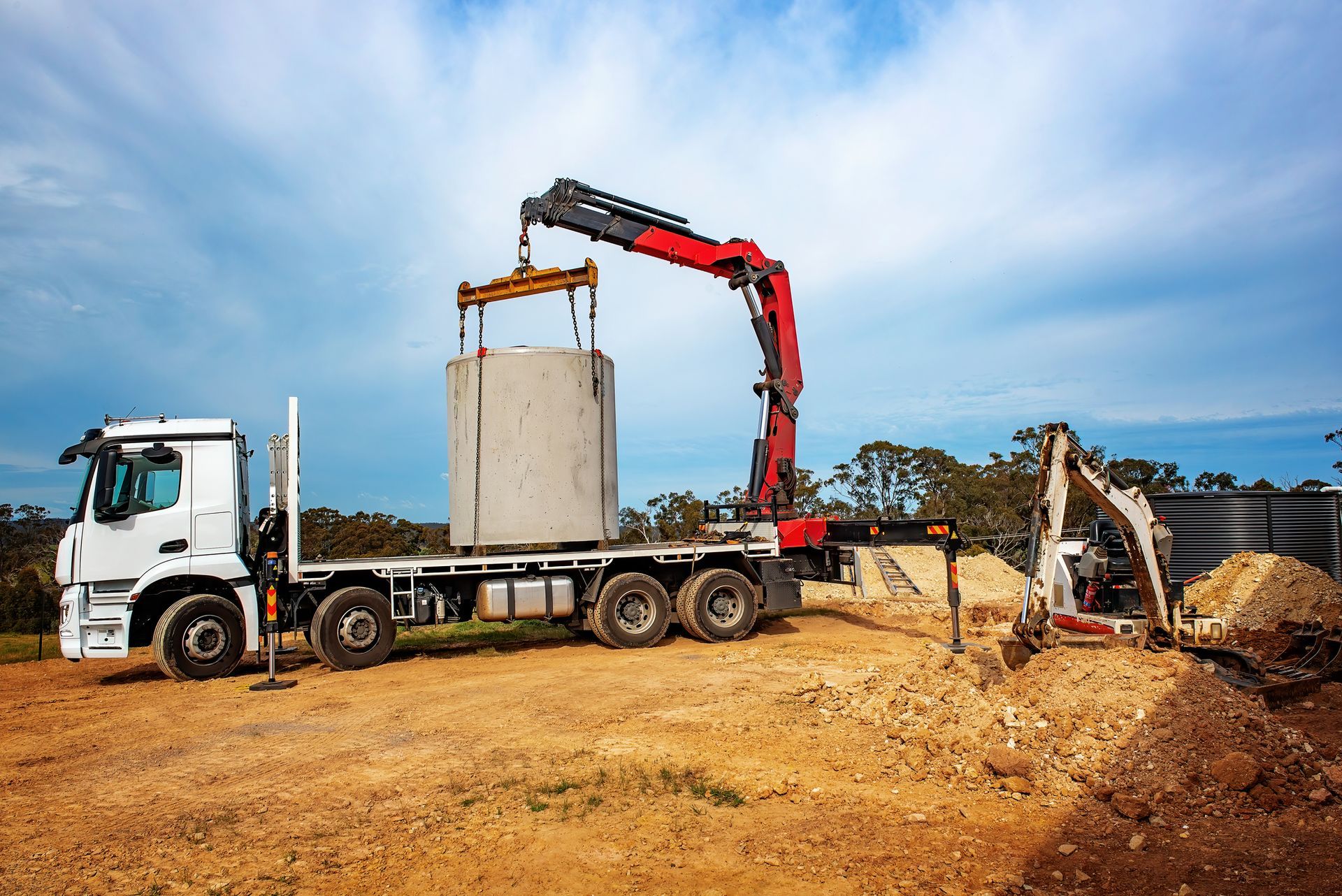 Septic tank being placed on a truck— Frank Plumbing In Delacombe, VIC