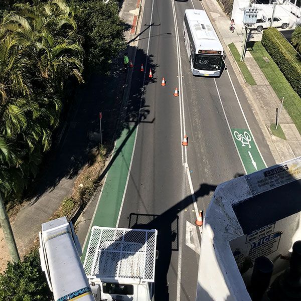 An Aerial View of a Bus Driving Down a Street — Tallow Tree Services Pty Ltd in Bangalow, NSW