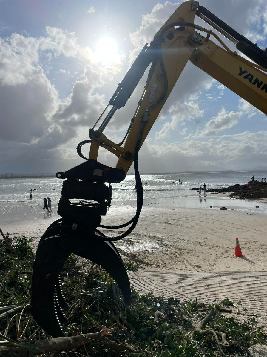 A Yankee Excavator is Working on a Beach — Tallow Tree Services Pty Ltd in Casino, NSW