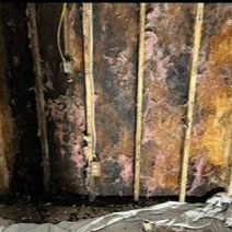 A man in a white shirt and blue pants is kneeling down