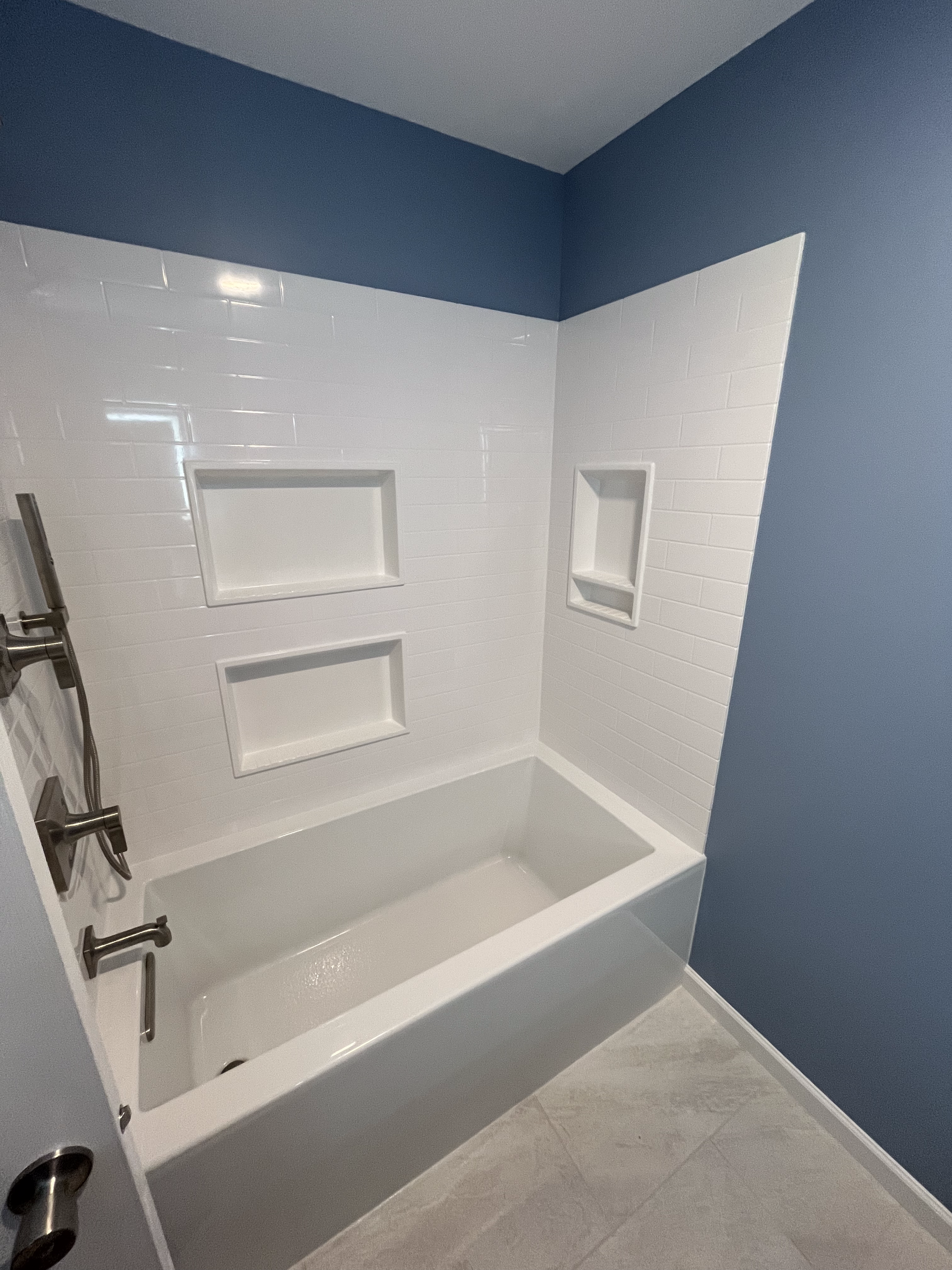 A bathroom with a bathtub and a shower.